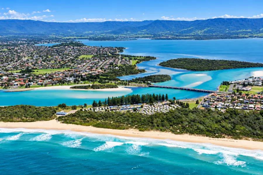 Aerial view of the Lake Illawarra entrance and Windang Bridge, with the lake and the Illawarra escarpment behind